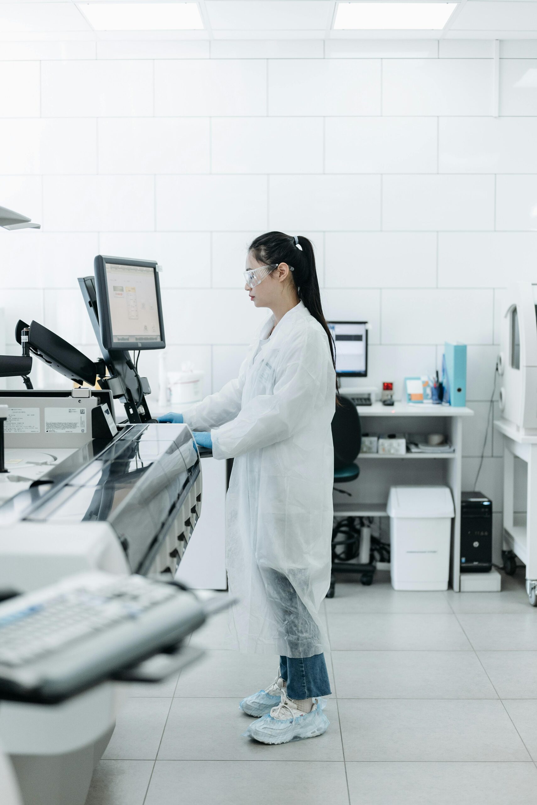 Lab scientist conducting research in a high-tech laboratory environment.